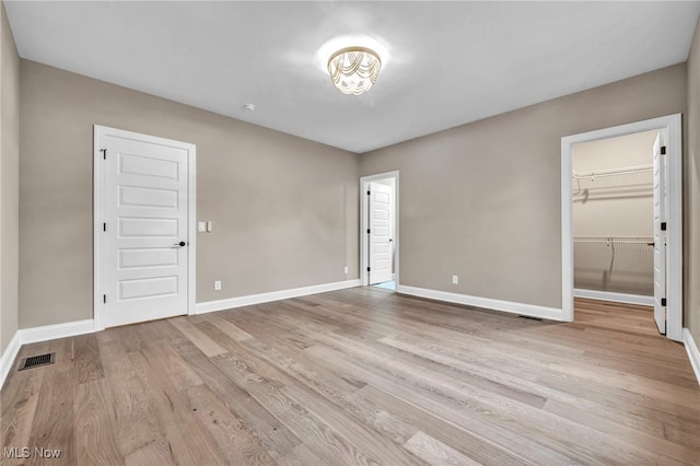 unfurnished room with light wood-type flooring