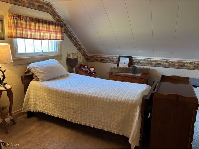 bedroom featuring vaulted ceiling and carpet