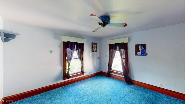 empty room featuring ceiling fan and carpet flooring