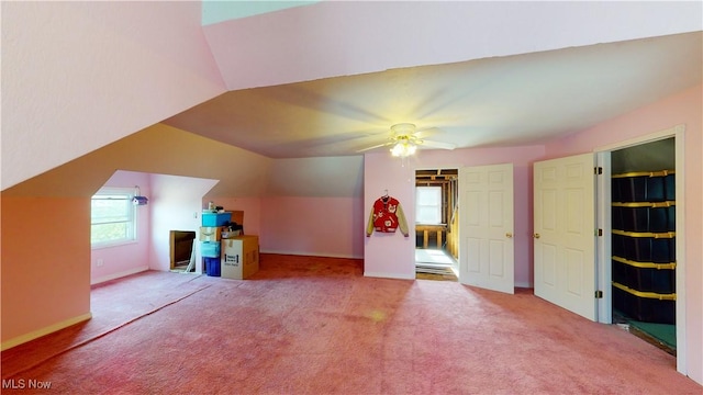 bonus room with ceiling fan, lofted ceiling, and carpet