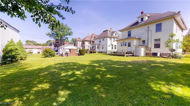 rear view of property with a deck, central air condition unit, and a lawn