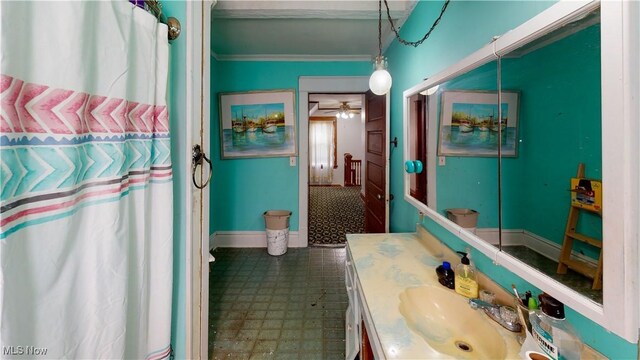 bathroom featuring vanity, ornamental molding, and curtained shower