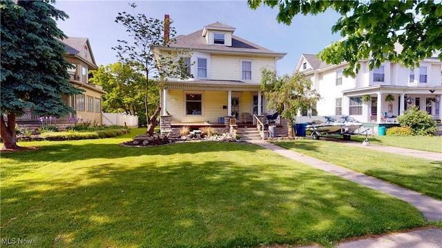 view of front of house with covered porch and a front lawn