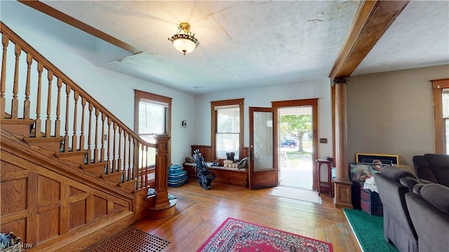 entryway featuring hardwood / wood-style flooring, a healthy amount of sunlight, and a textured ceiling