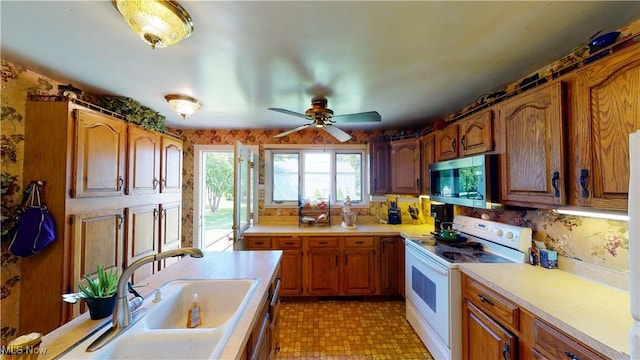 kitchen with ceiling fan, sink, and electric range