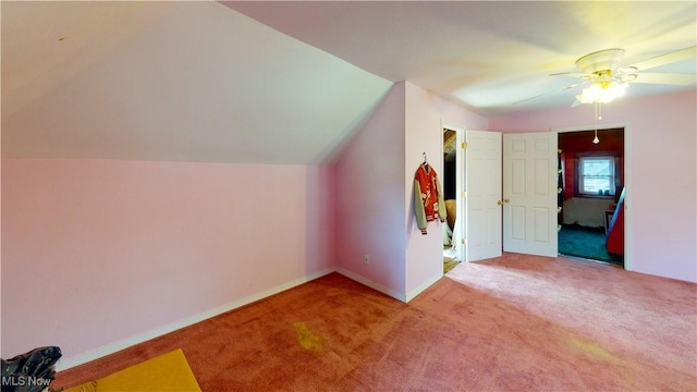 bonus room with vaulted ceiling, light colored carpet, and ceiling fan