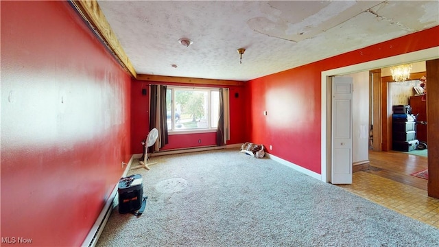 interior space featuring light colored carpet and a textured ceiling