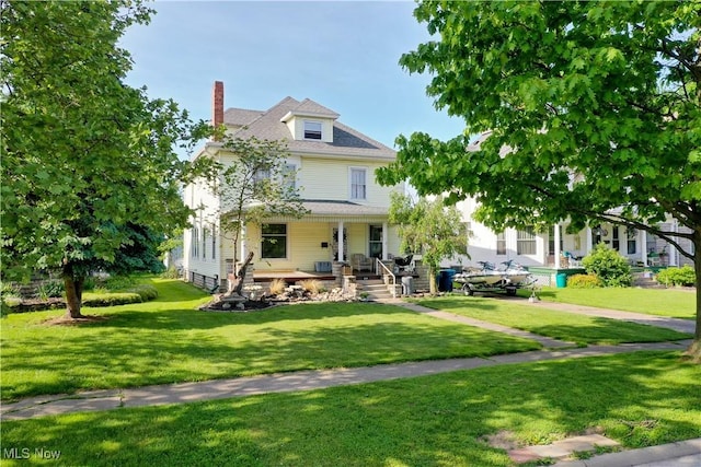 view of front of house with a porch and a front lawn