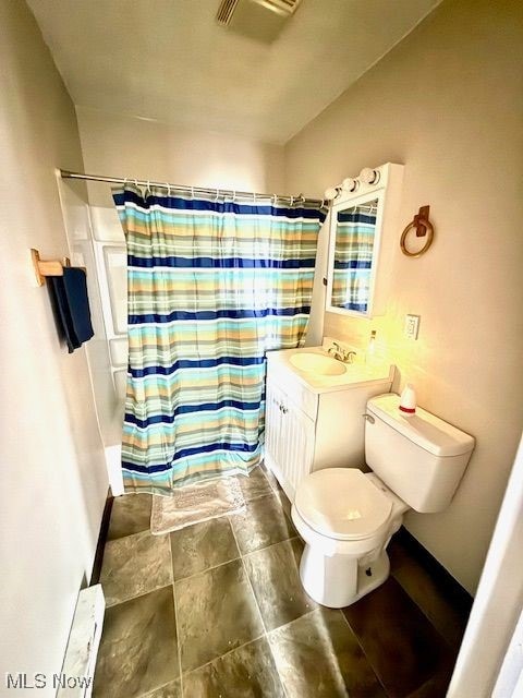 bathroom featuring vanity, toilet, and a shower with shower curtain