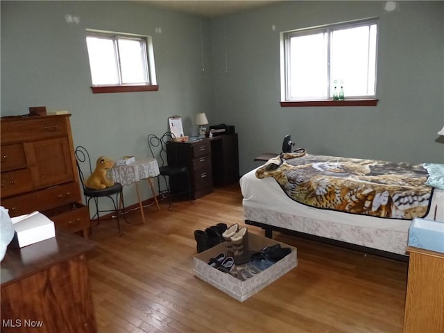 bedroom with hardwood / wood-style floors