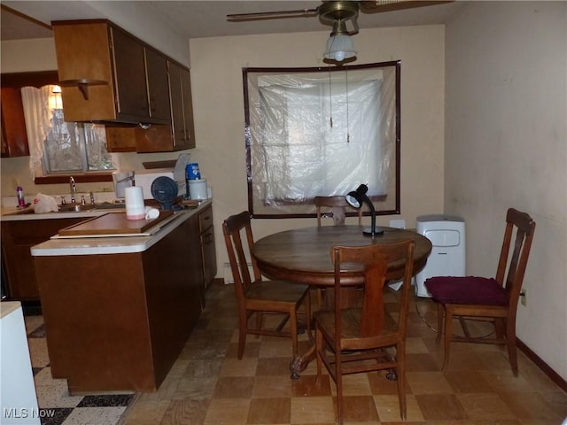 dining area with sink and ceiling fan