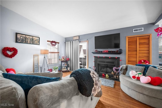 living room with lofted ceiling and light hardwood / wood-style floors