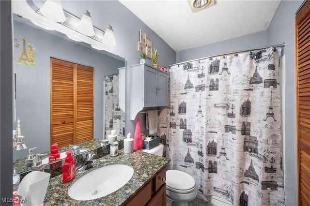 bathroom featuring vanity, curtained shower, and toilet