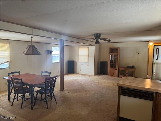 dining area featuring light carpet and ceiling fan