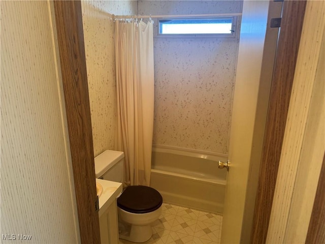 full bathroom featuring shower / bath combo, vanity, and toilet