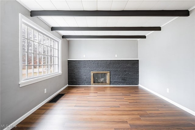 unfurnished living room featuring hardwood / wood-style flooring, a fireplace, and beam ceiling