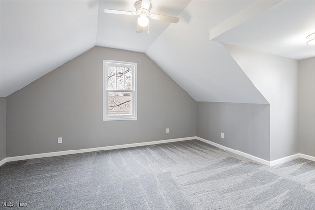 additional living space with vaulted ceiling, light carpet, and ceiling fan