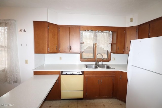 kitchen featuring white appliances and sink