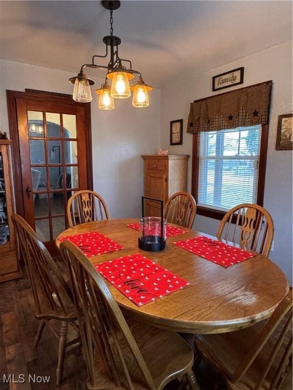 dining space with wood-type flooring