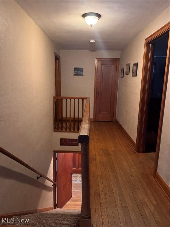 hallway with hardwood / wood-style flooring