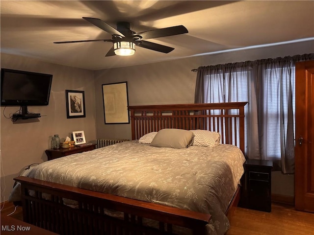 bedroom featuring wood-type flooring and ceiling fan