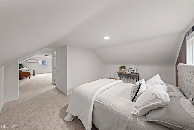 bedroom with a wall mounted AC, vaulted ceiling, and light carpet