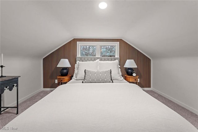 carpeted bedroom with lofted ceiling