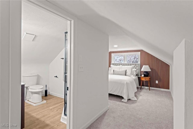 bedroom with lofted ceiling and light hardwood / wood-style flooring