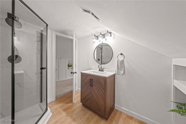 bathroom featuring vanity, hardwood / wood-style floors, and an enclosed shower