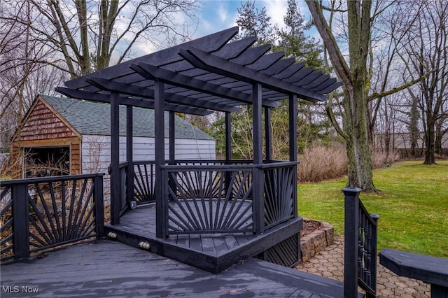 wooden deck with a pergola, a garage, a yard, and an outdoor structure