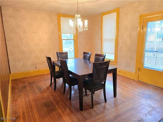 dining room featuring an inviting chandelier, hardwood / wood-style floors, and a healthy amount of sunlight