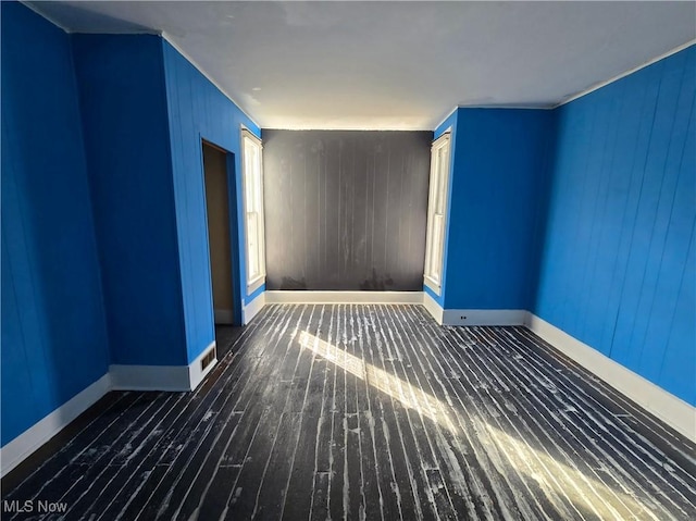 empty room with dark hardwood / wood-style flooring