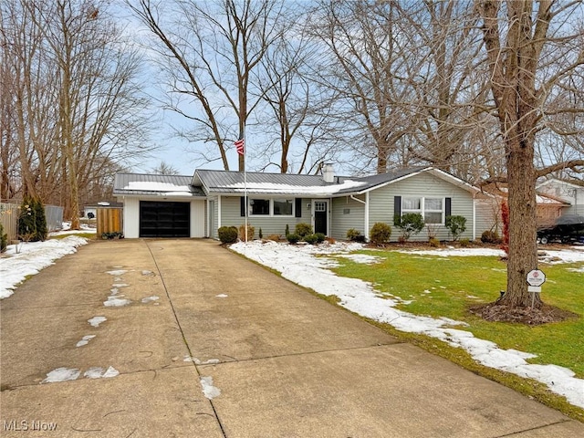 single story home with a garage and a front lawn