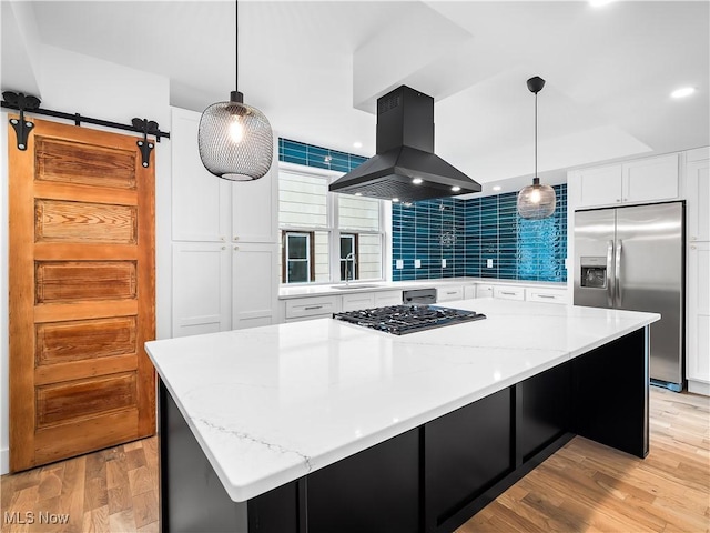 kitchen featuring decorative light fixtures, island exhaust hood, stainless steel appliances, a large island, and white cabinets