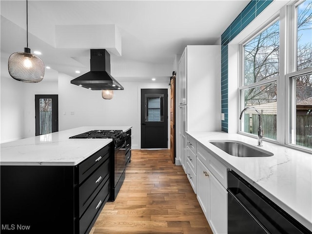 kitchen featuring sink, decorative light fixtures, black appliances, island exhaust hood, and white cabinets