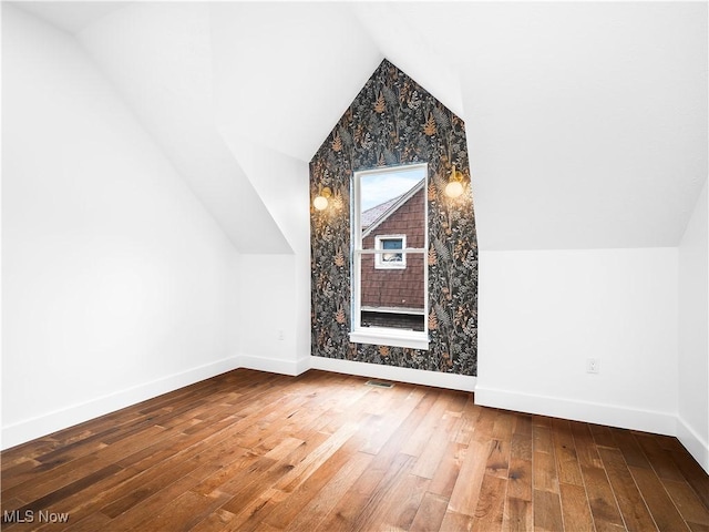 bonus room featuring lofted ceiling and wood-type flooring