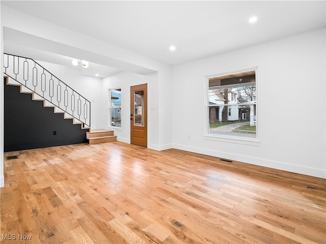 unfurnished living room featuring light wood-type flooring