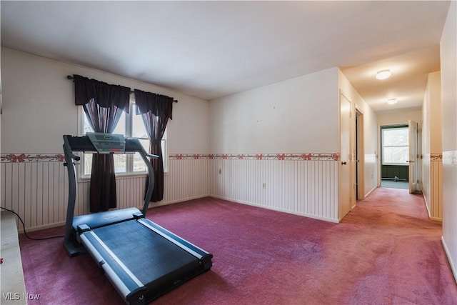 exercise room with carpet floors and radiator