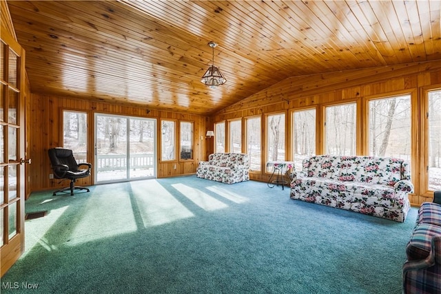 interior space featuring wood ceiling, vaulted ceiling, carpet, and wood walls