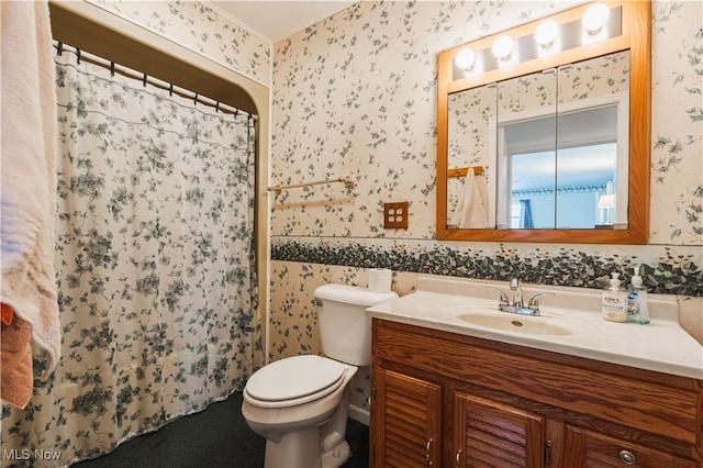 bathroom featuring vanity, curtained shower, and toilet