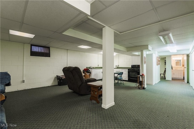 basement with carpet and a paneled ceiling