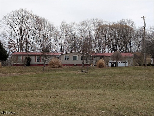 view of front of home featuring a garage and a front lawn