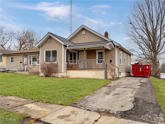 bungalow-style house with a front yard and covered porch