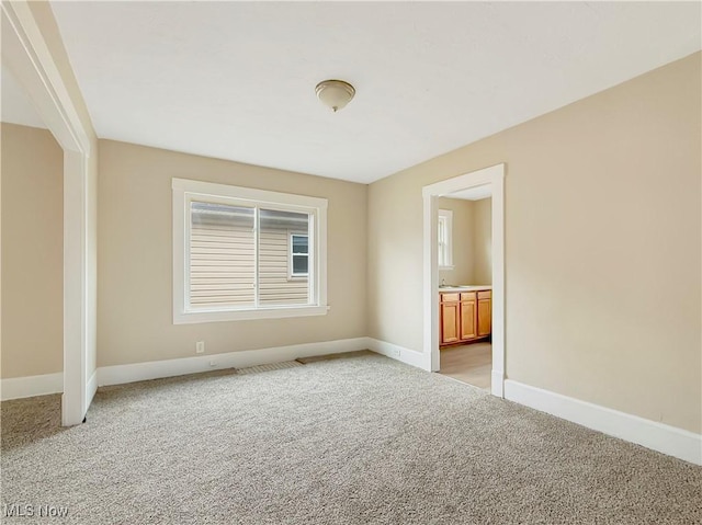 unfurnished room featuring light carpet