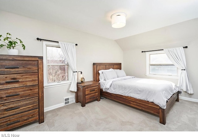 carpeted bedroom featuring vaulted ceiling