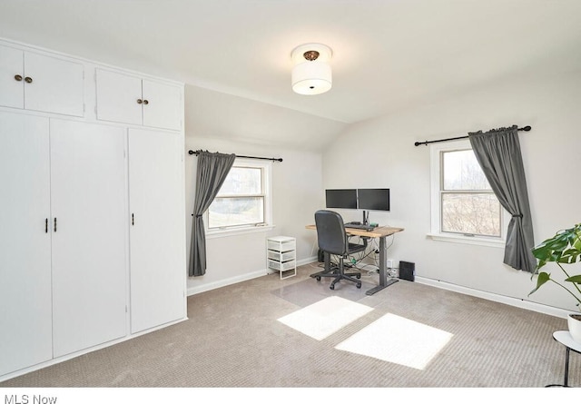 carpeted office space with lofted ceiling