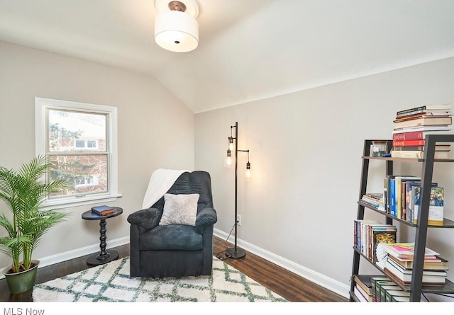 sitting room featuring lofted ceiling and dark hardwood / wood-style floors