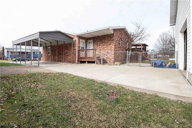 exterior space with a carport and a yard