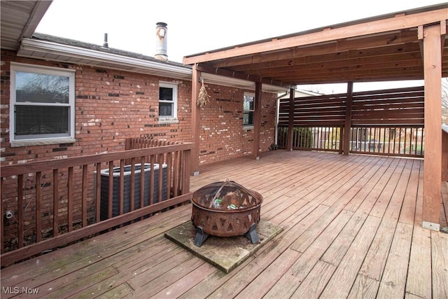 wooden terrace with an outdoor fire pit