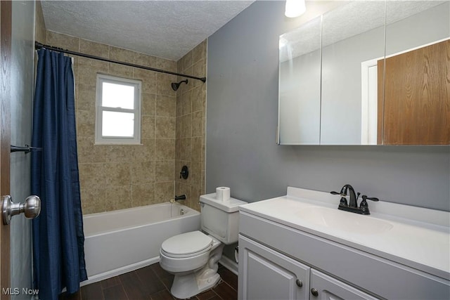 full bathroom with shower / tub combo with curtain, toilet, a textured ceiling, vanity, and hardwood / wood-style flooring